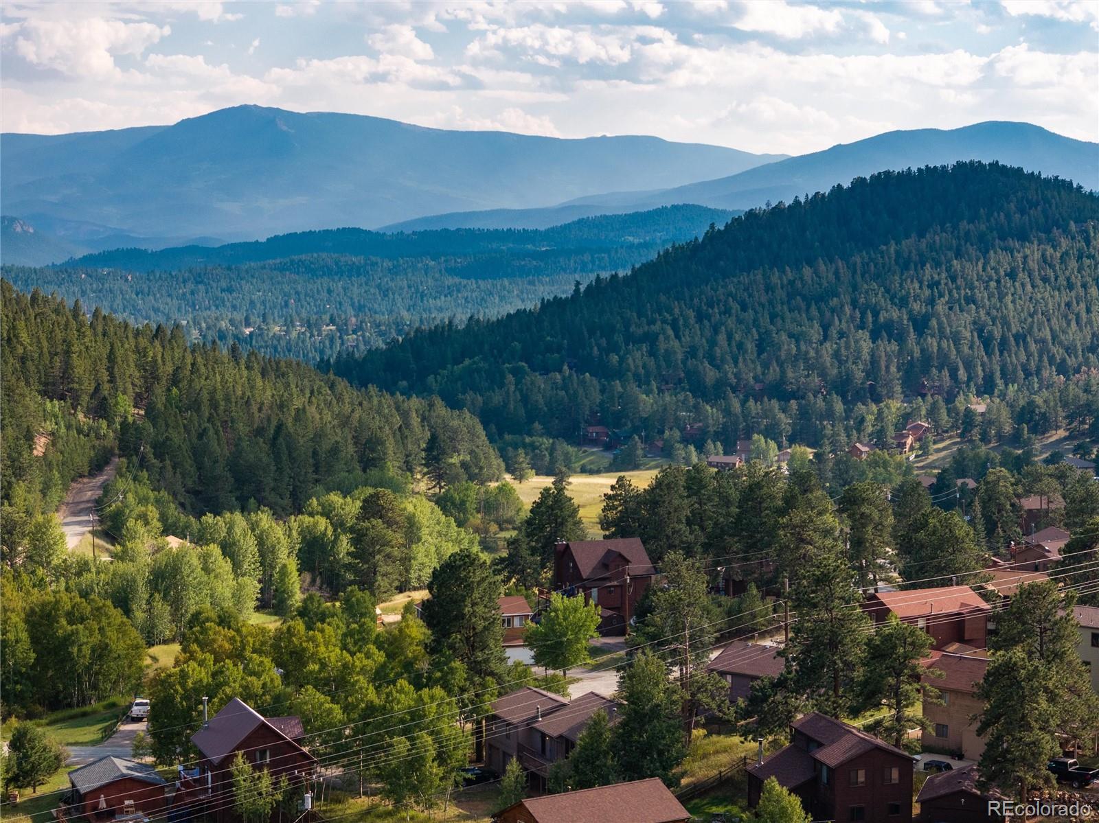 65 Silver Springs Road Bailey, CO 80421 - Photo 38 of 45 a view of a lake with mountains in the background