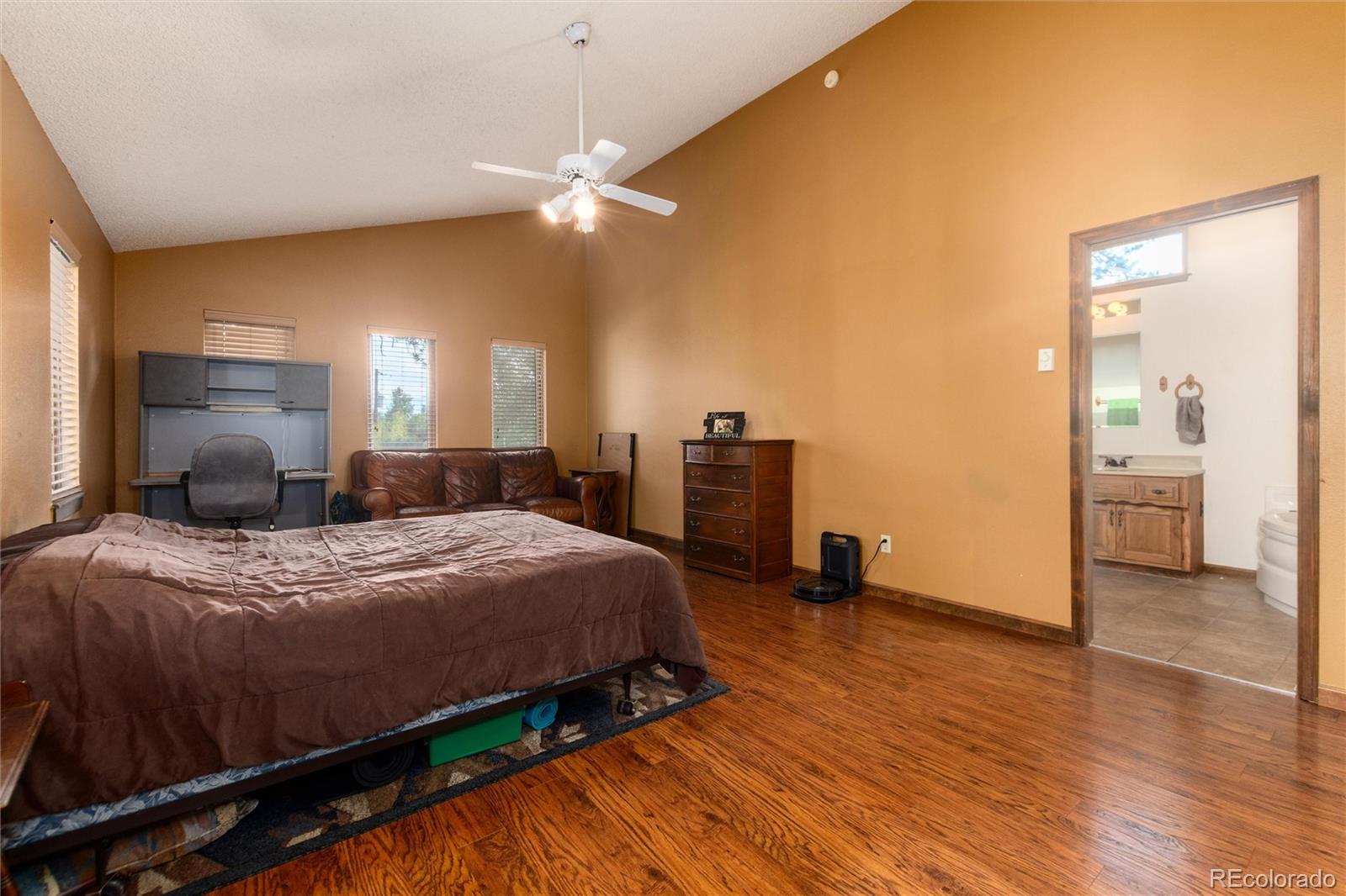 65 Silver Springs Road Bailey, CO 80421 - Photo 6 of 38 a bedroom with a bed and wooden floor