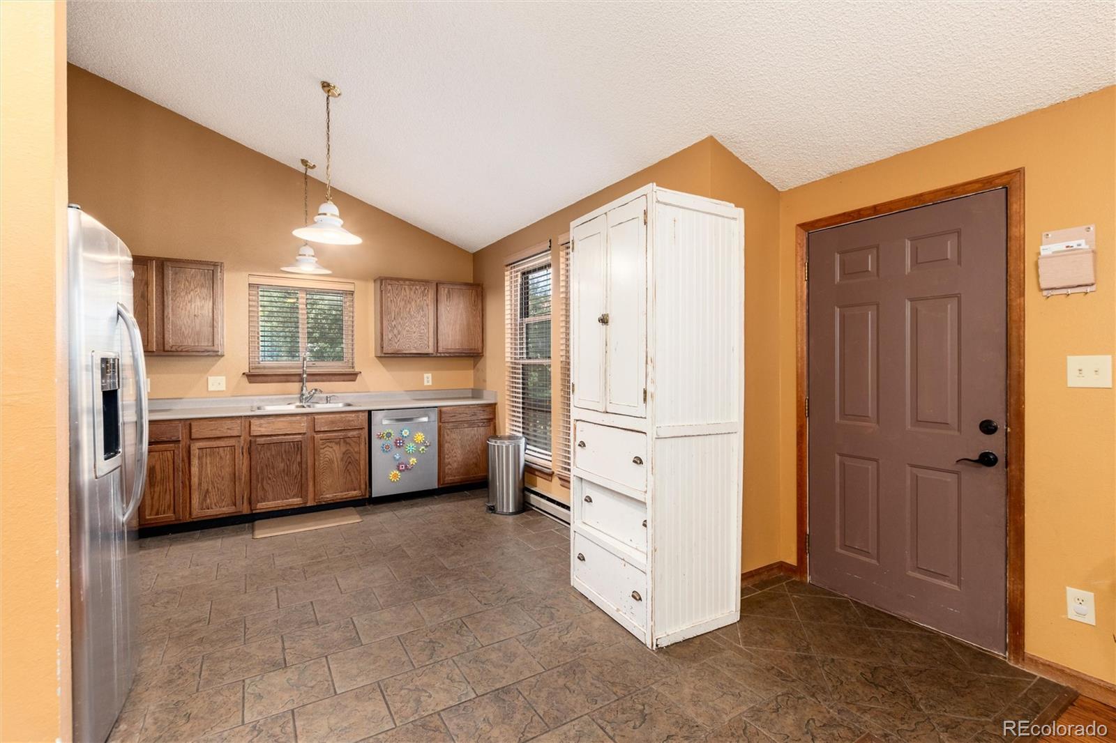 65 Silver Springs Road Bailey, CO 80421 - Photo 6 of 45 a kitchen with stainless steel appliances a refrigerator sink and cabinets