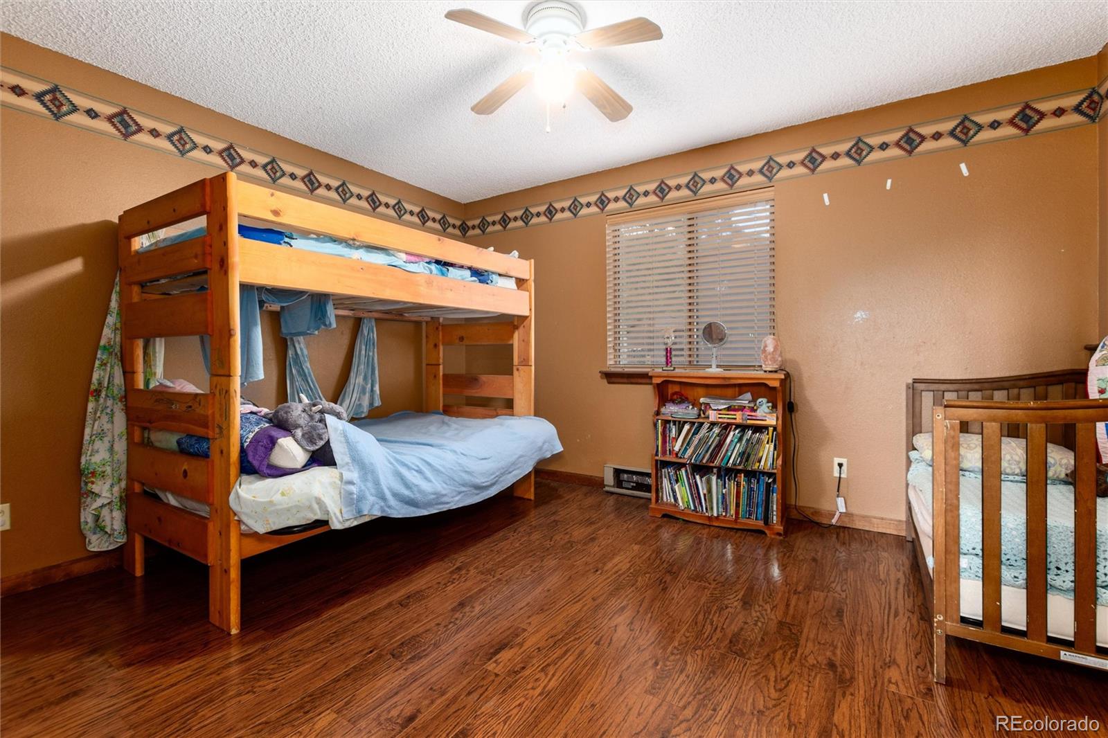 65 Silver Springs Road Bailey, CO 80421 - Photo 10 of 38 a bedroom with furniture and wooden floor