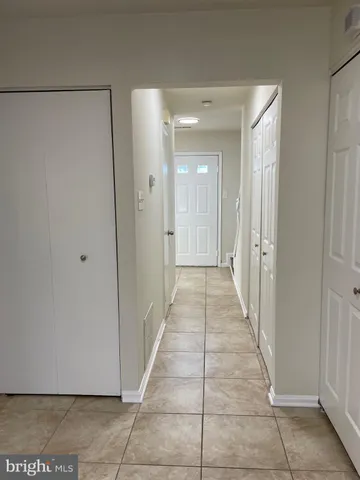 a kitchen with granite countertop a stove a sink and a refrigerator