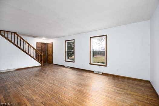 4293 Good Road Seville, OH 44273 - Photo 18 of 35 Unfurnished living room with stairway and dark wood finished floors