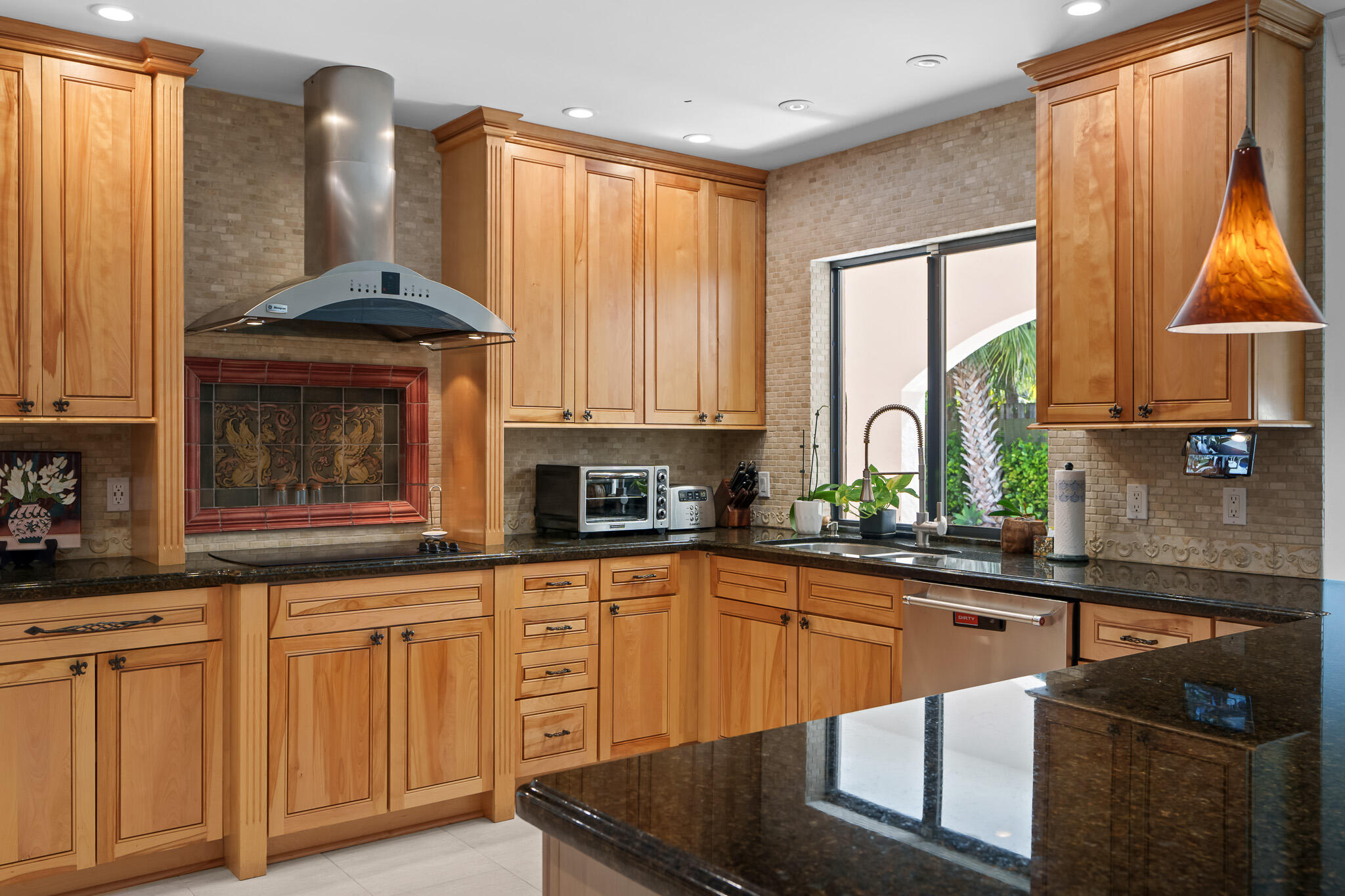 23397 Lago Mar Circle Boca Raton, FL 33433 - Photo 23 of 70 a kitchen with stainless steel appliances granite countertop a stove a sink and a microwave