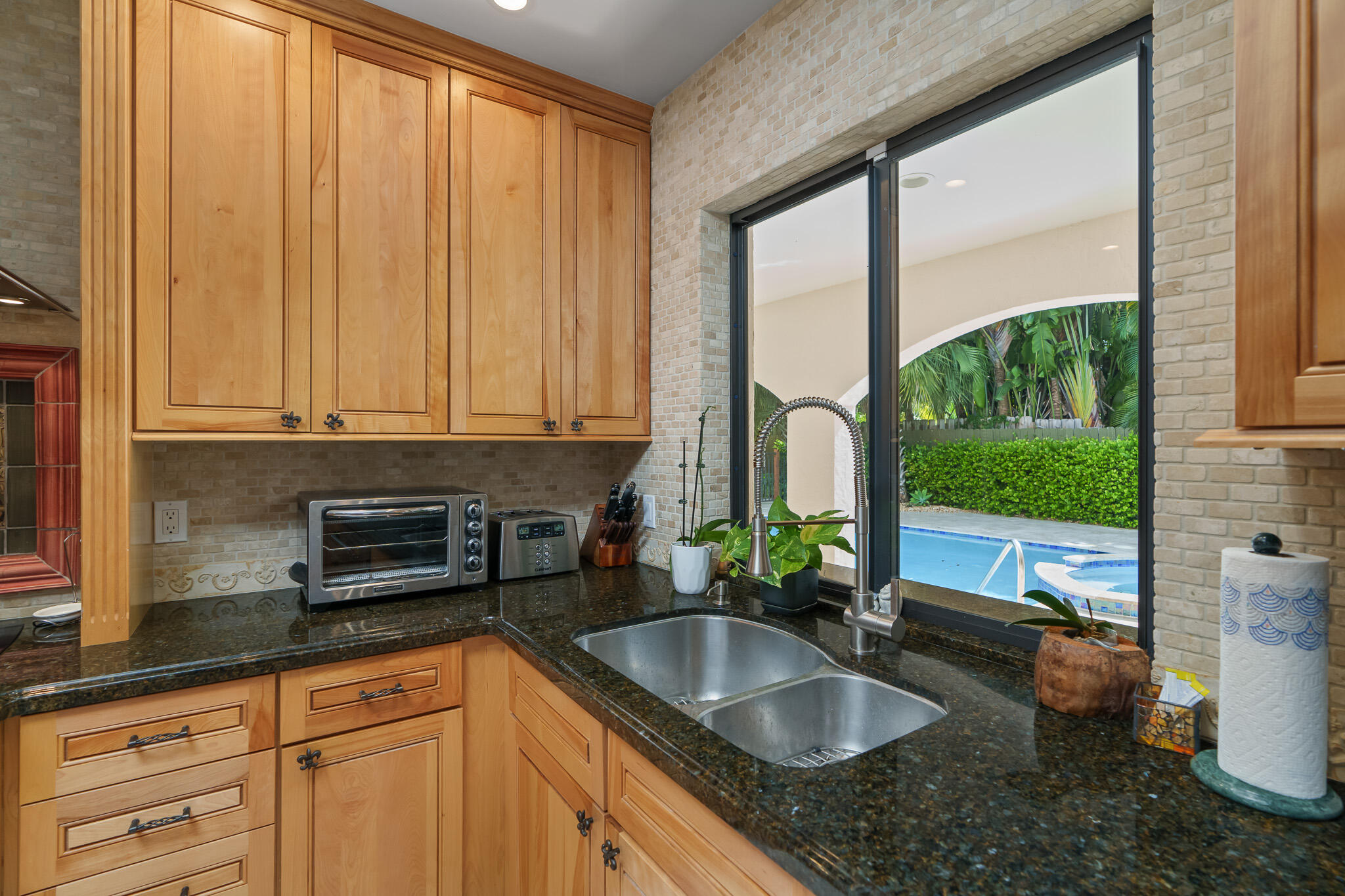 23397 Lago Mar Circle Boca Raton, FL 33433 - Photo 25 of 70 a kitchen with granite countertop a sink a counter top space and cabinets