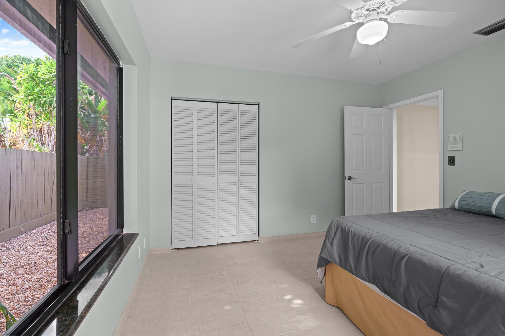 23397 Lago Mar Circle Boca Raton, FL 33433 - Photo 44 of 70 a bedroom with a large bed and a chandelier