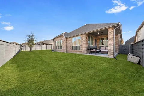 a view of a house with a yard and sitting area