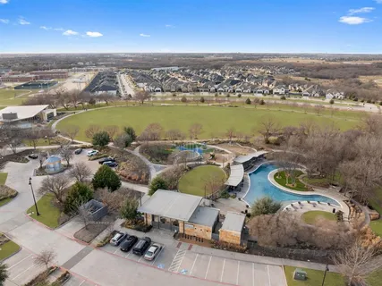 an aerial view of a house with swimming pool and ocean view