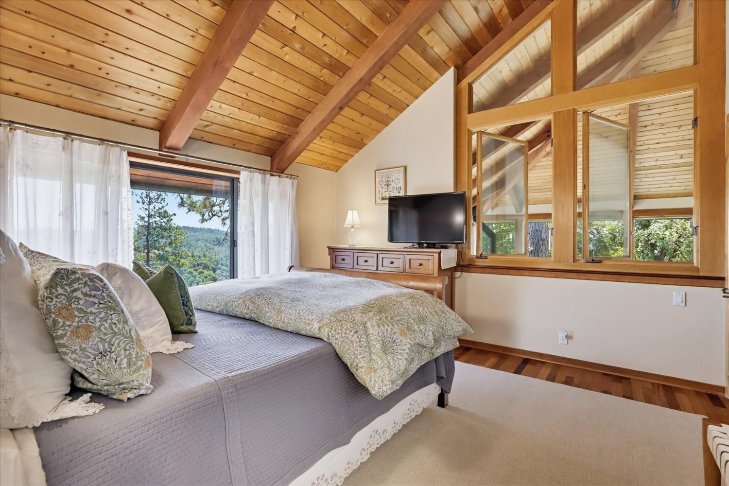 20111 Tanglewood Road Grass Valley, CA 95945 - Photo 38 of 93 a bedroom with a large bed and a large window with outer view