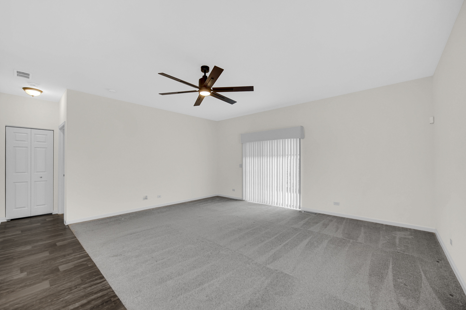 925 Baltimore Street McHenry, IL 60050 - Photo 12 of 27 an empty room with wooden floor and windows