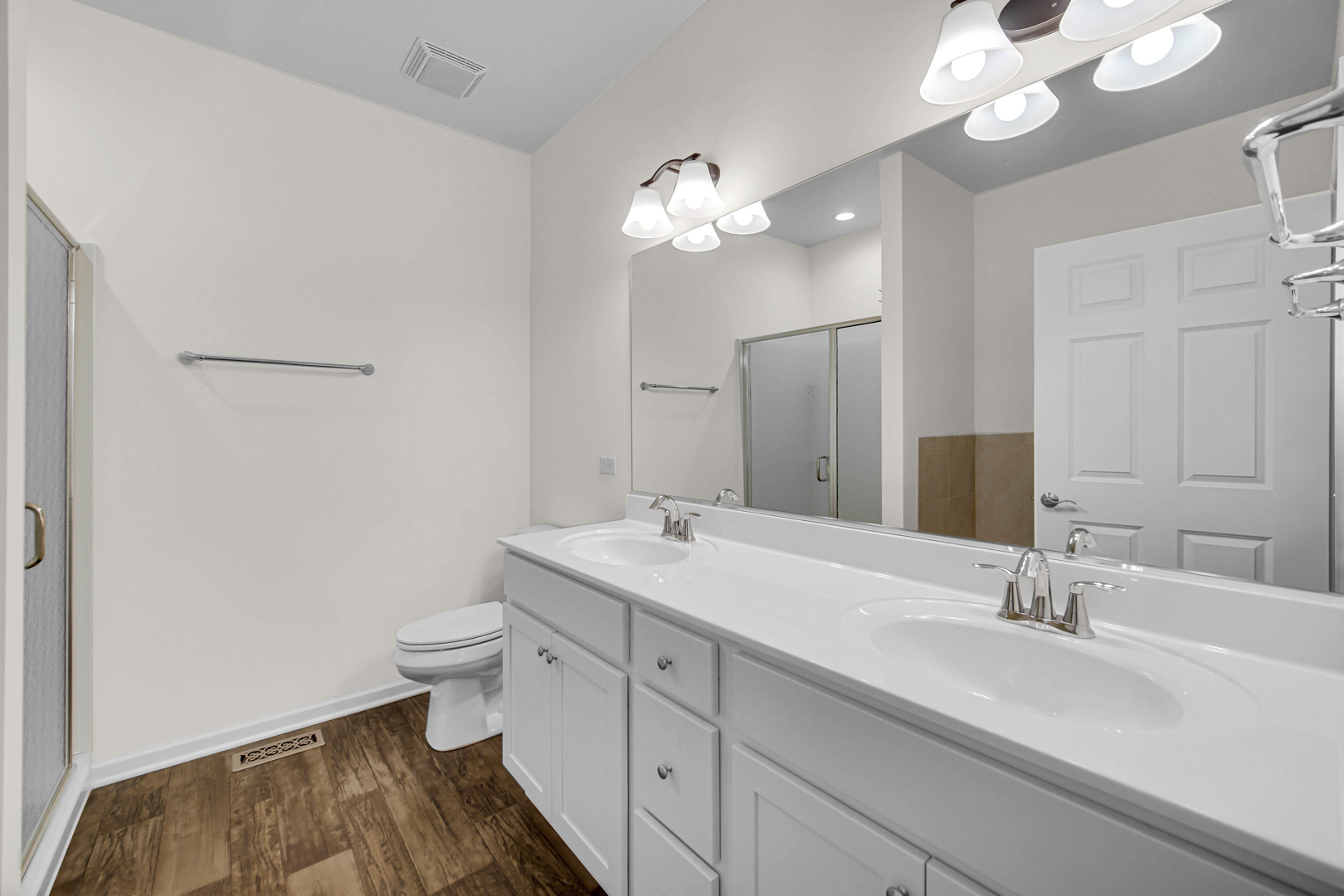 925 Baltimore Street McHenry, IL 60050 - Photo 16 of 27 a bathroom with a sink a toilet and a mirror