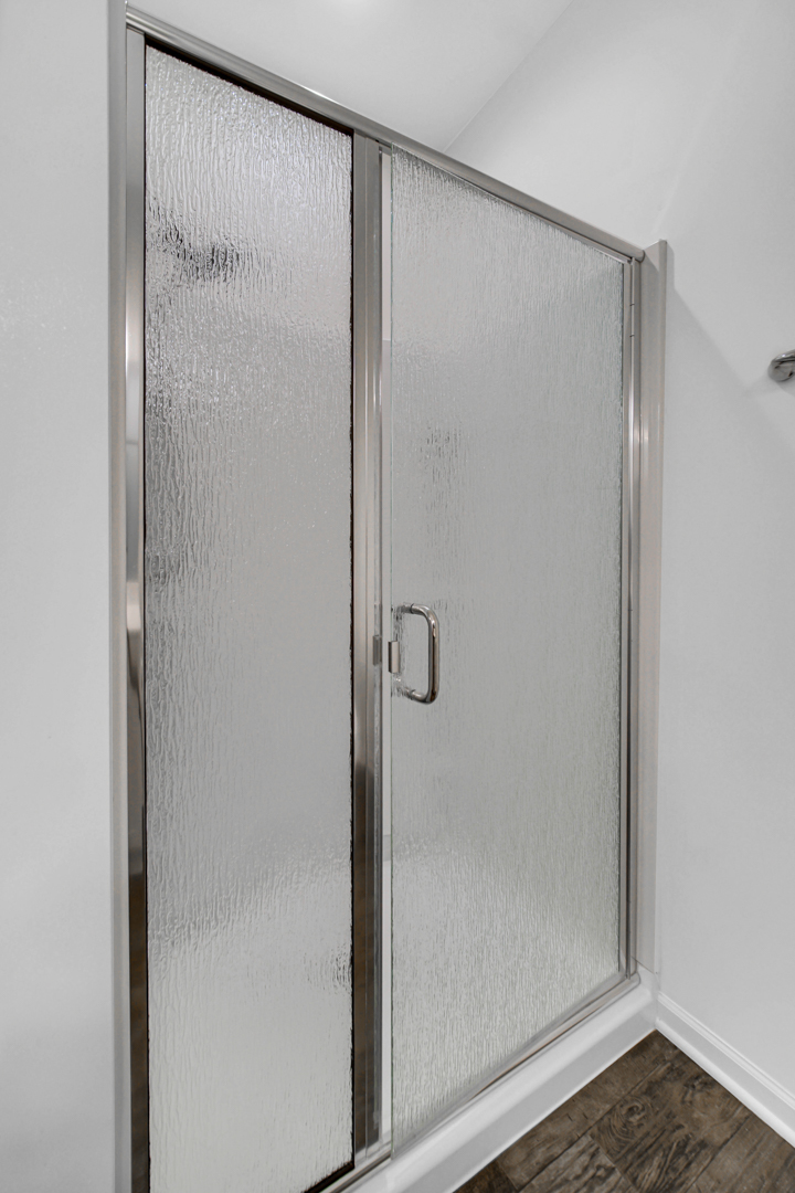 925 Baltimore Street McHenry, IL 60050 - Photo 17 of 27 a bathroom with a glass shower door