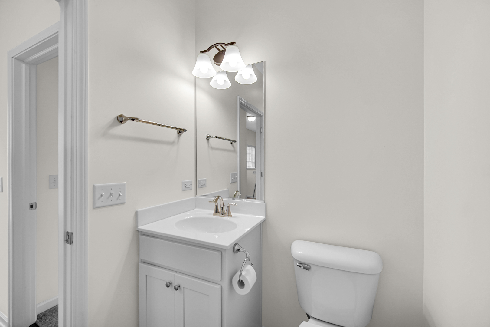 925 Baltimore Street McHenry, IL 60050 - Photo 21 of 27 a bathroom with a toilet a sink and mirror