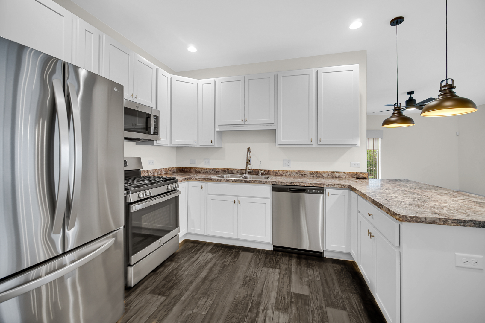 925 Baltimore Street McHenry, IL 60050 - Photo 7 of 27 a kitchen with granite countertop stainless steel appliances and wooden cabinets