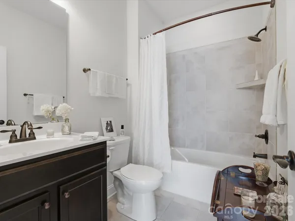 a bathroom with a sink toilet vanity and shower