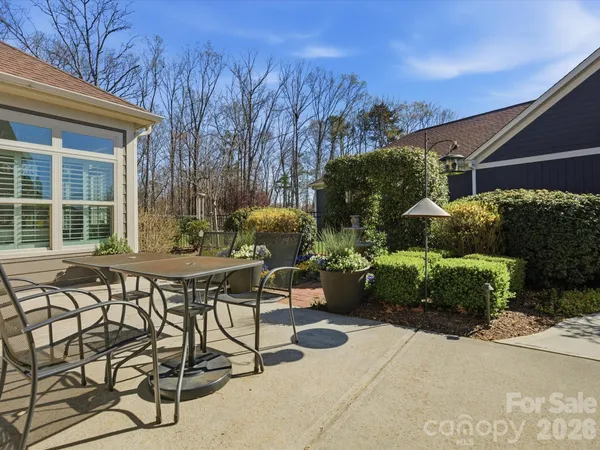 a view of a patio with table and chairs and potted plants