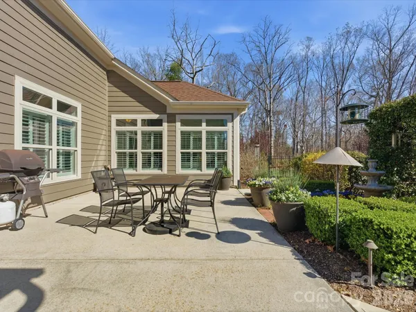 a view of a patio with table and chairs under an umbrella