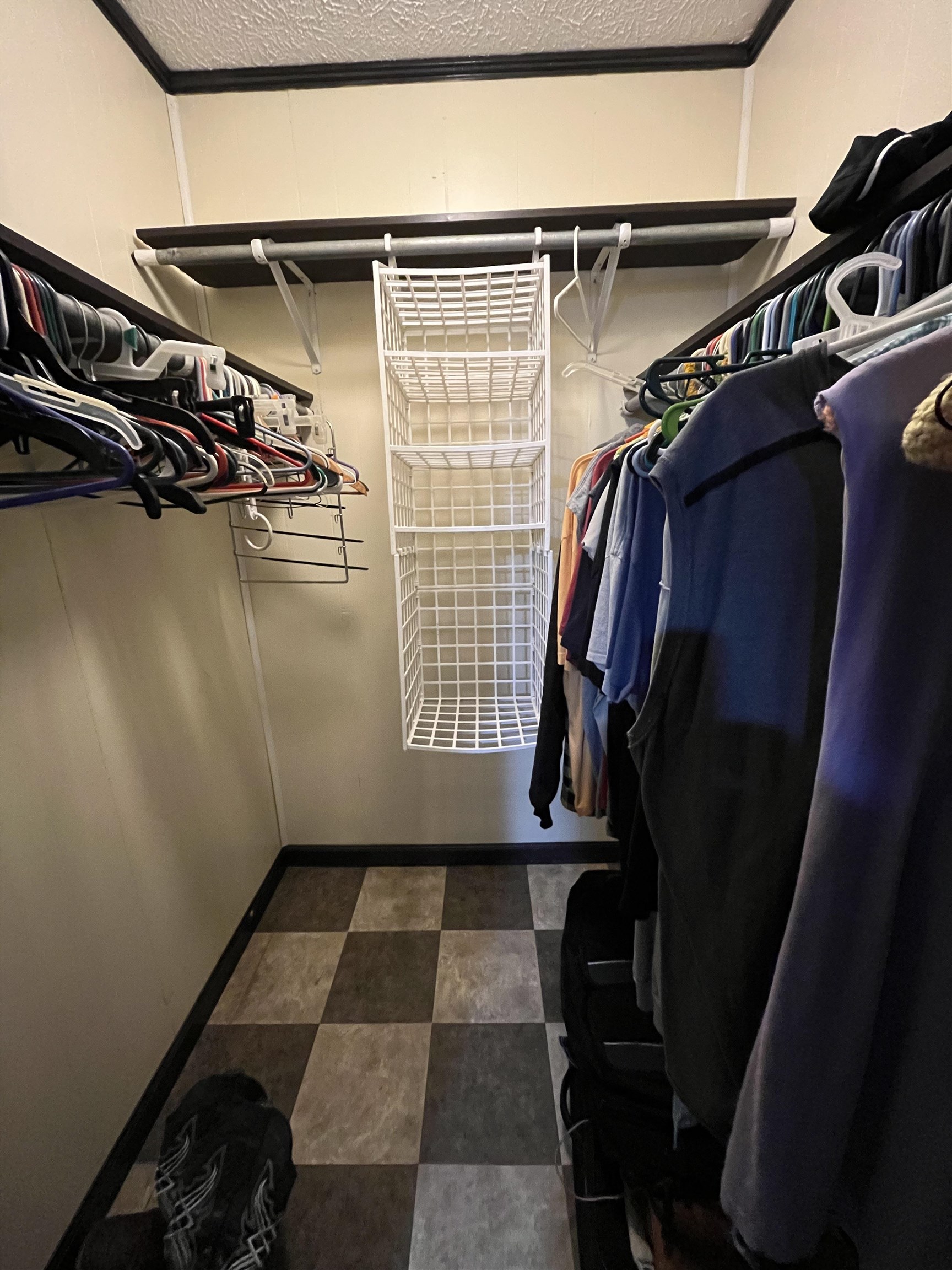 1125 Tyson Road Toone, TN 38381 - Photo 10 of 12 Walk-in closet featuring checkerboard flooring, upper shelving, and white wire hanging storage