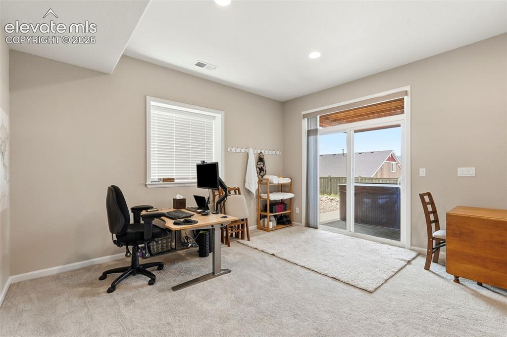 1394 Promontory Bluff View Colorado Springs, CO 80921 - Photo 31 of 47 a view of a workspace with furniture and a window