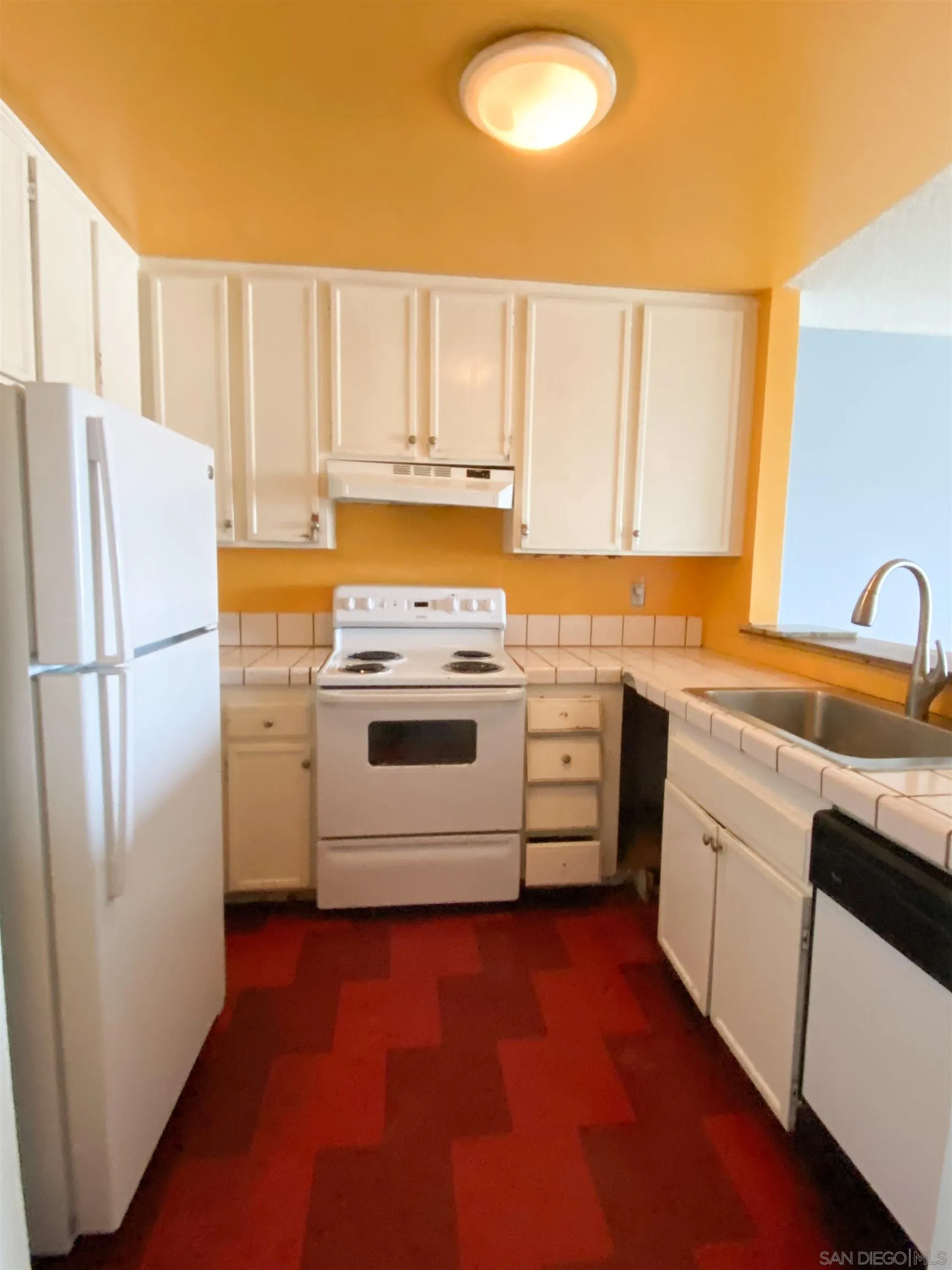 3955 Faircross Place, Unit 45 San Diego, CA 92115 - Photo 2 of 14 a kitchen with a refrigerator sink and cabinets