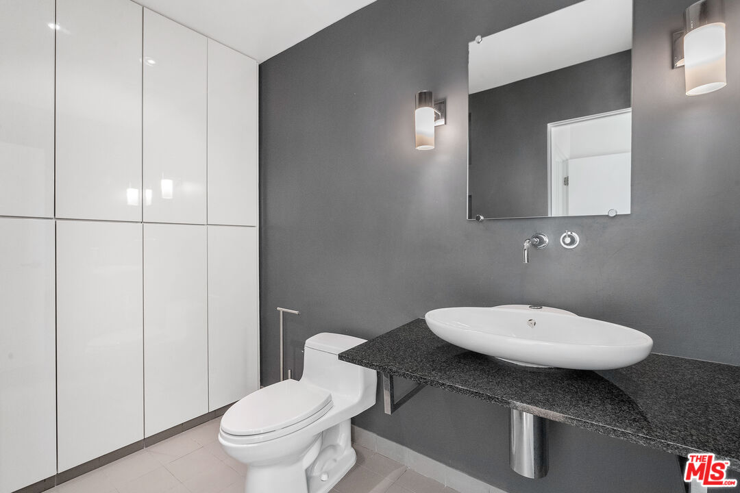 6801 Seawatch Lane Malibu, CA 90265 - Photo 11 of 28 a bathroom with a toilet sink and mirror