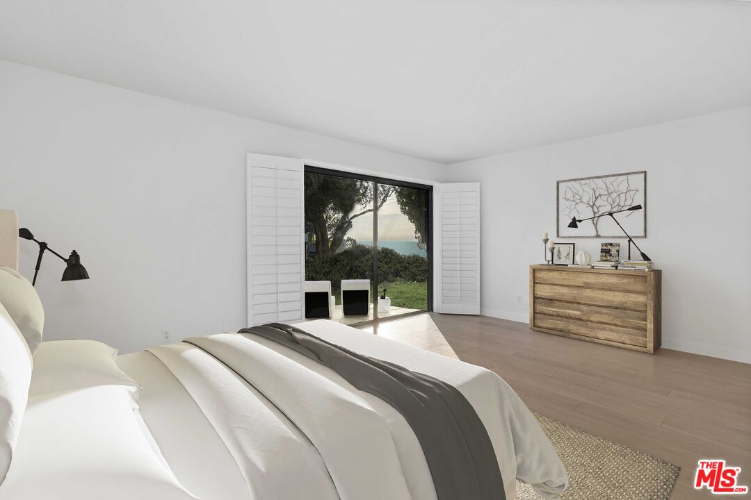 6801 Seawatch Lane Malibu, CA 90265 - Photo 13 of 28 a bedroom with a bed and a painting on the wall