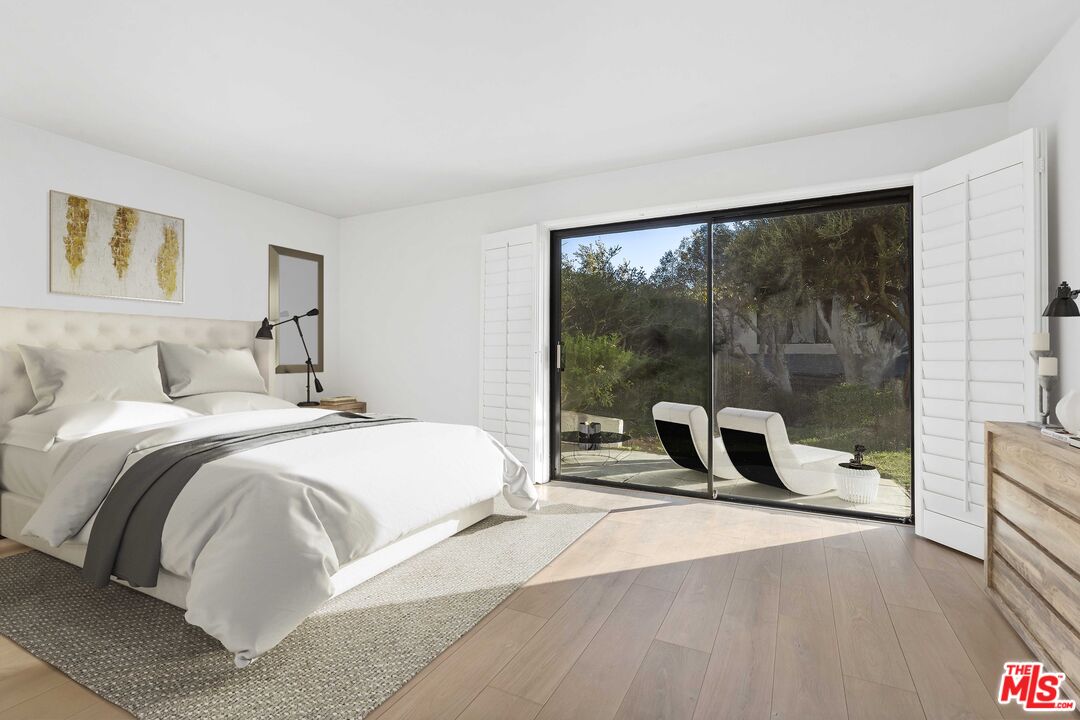 6801 Seawatch Lane Malibu, CA 90265 - Photo 14 of 28 a bedroom with a bed and a large window