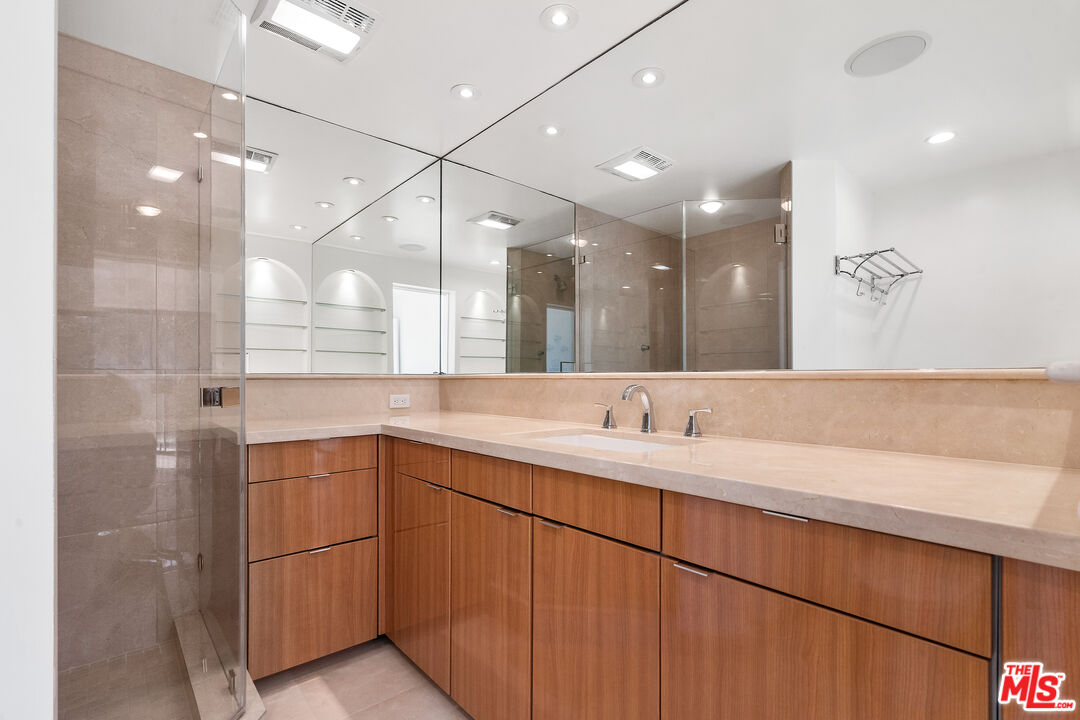 6801 Seawatch Lane Malibu, CA 90265 - Photo 15 of 28 a bathroom with a double vanity sink a mirror and a shower