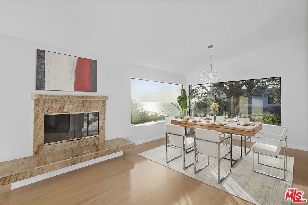 6801 Seawatch Lane Malibu, CA 90265 - Photo 5 of 28 a living room with furniture a fireplace and a floor to ceiling window
