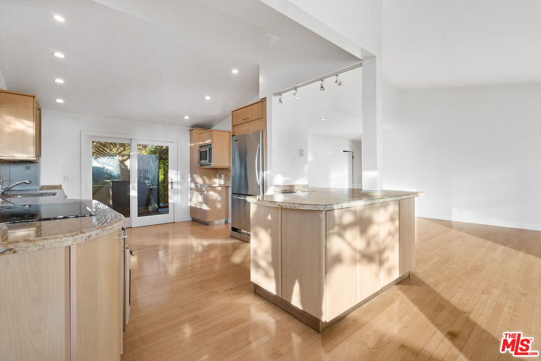 6801 Seawatch Lane Malibu, CA 90265 - Photo 7 of 28 a view of a kitchen with kitchen island granite countertop living room