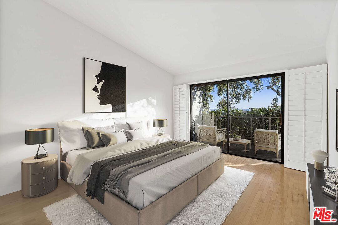 6801 Seawatch Lane Malibu, CA 90265 - Photo 9 of 28 a bedroom with a large bed and a large window