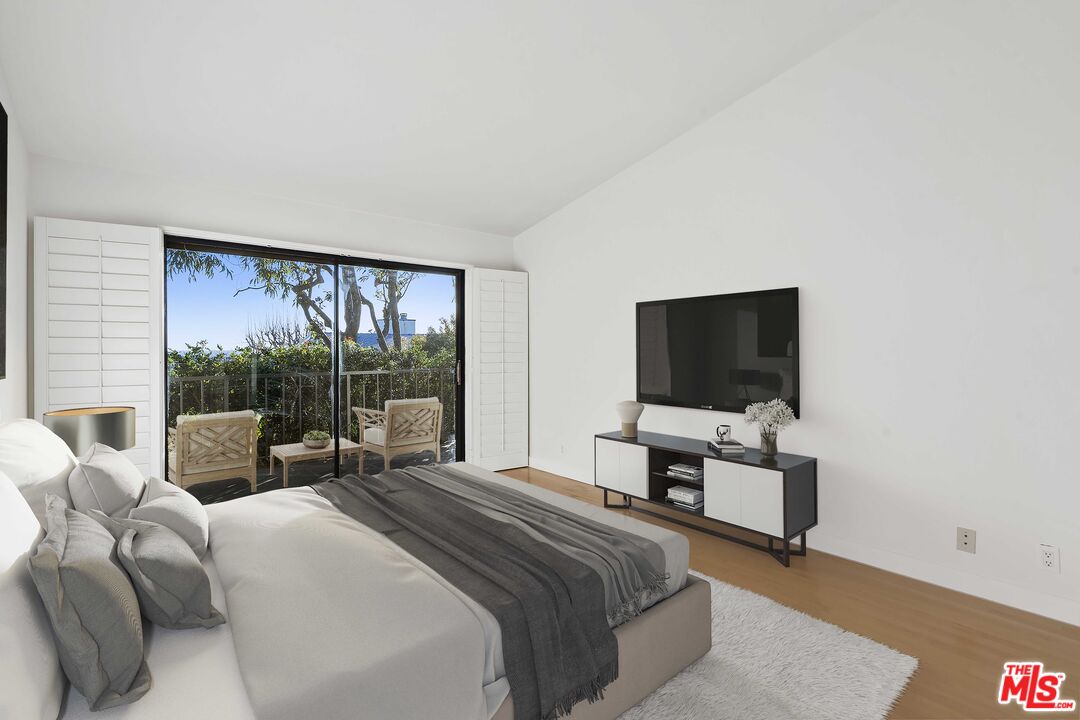 6801 Seawatch Lane Malibu, CA 90265 - Photo 10 of 28 a bedroom with a bed and a flat screen tv