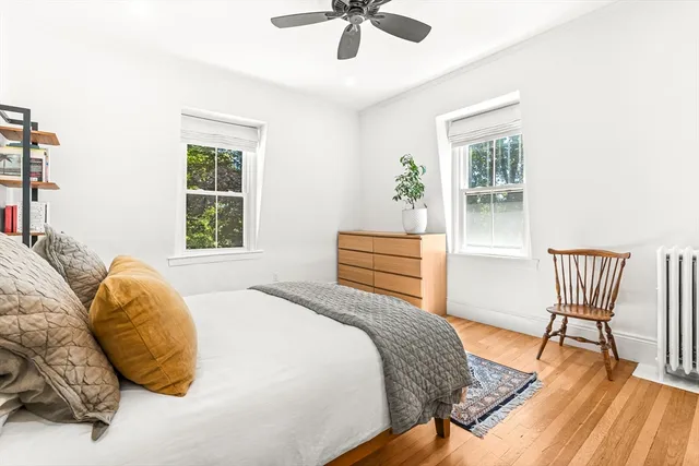 a bedroom with a bed and a chair