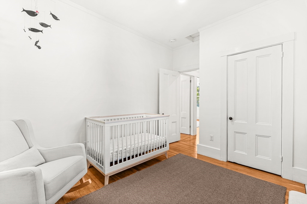 25 Sawin Street Natick, MA 01760 - Photo 18 of 19 a room with a baby crib and a couch