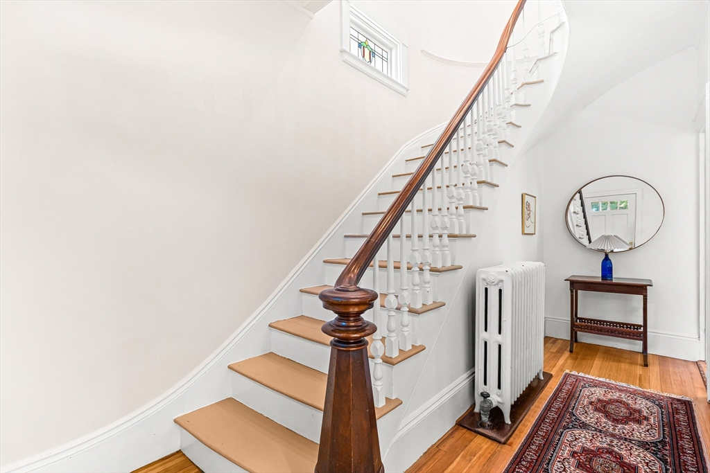25 Sawin Street Natick, MA 01760 - Photo 2 of 19 a view of staircase with a rug and a chandelier