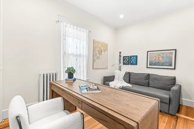 a living room with furniture and a potted plant