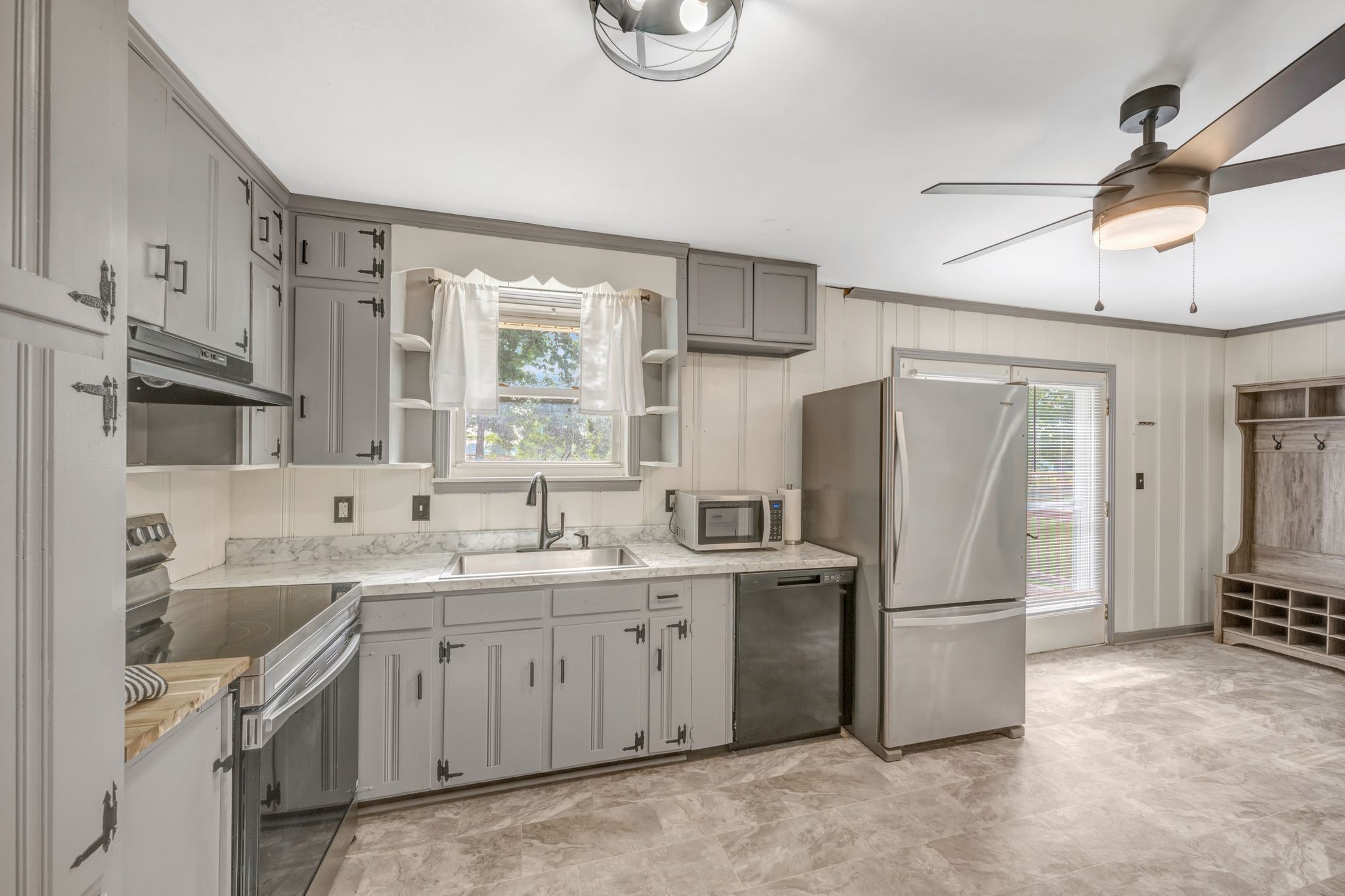 a kitchen with a sink appliances and cabinets