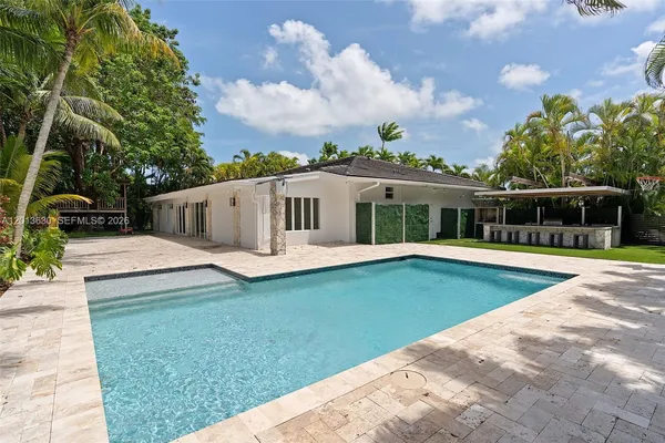 a view of house with swimming pool and view of a white house