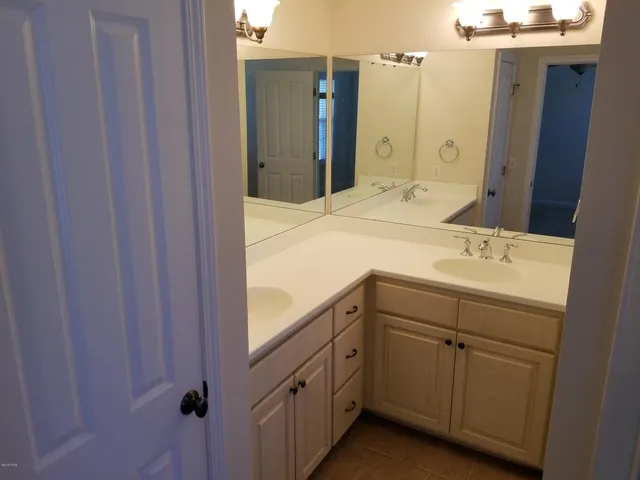 a bathroom with a double vanity sink and mirror