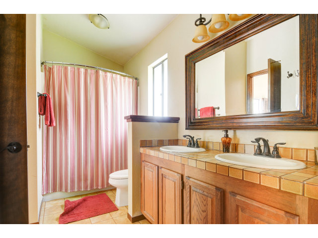 3075 El Toro Road Pebble Beach, CA 93953 - Photo 19 of 25 a bathroom with a sink a toilet and a mirror
