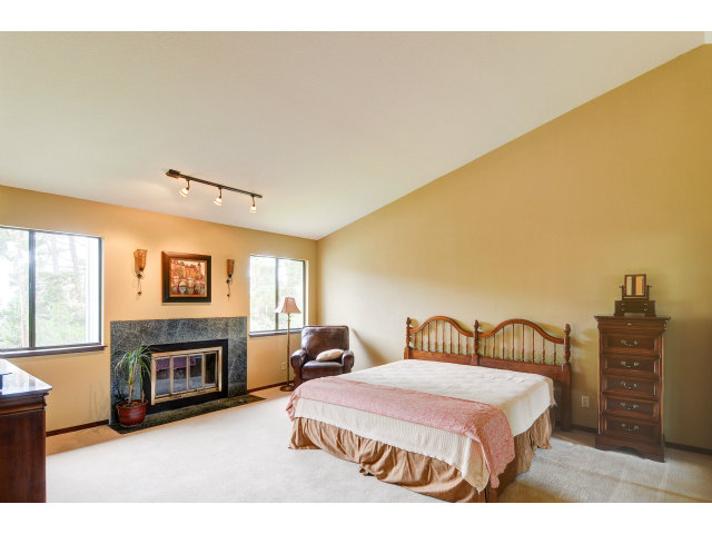3075 El Toro Road Pebble Beach, CA 93953 - Photo 20 of 25 a spacious bedroom with a bed and a television