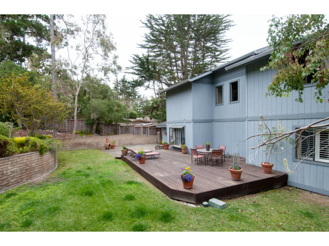 3075 El Toro Road Pebble Beach, CA 93953 - Photo 22 of 25 a view of a backyard with table and chairs potted plants and a palm tree