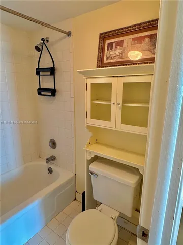 a bathroom with a toilet and a bathtub