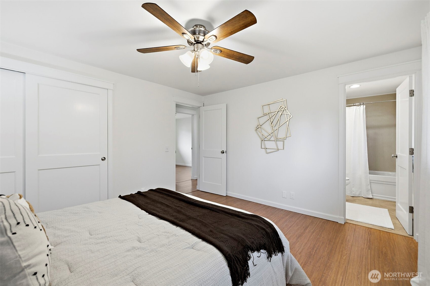 927 217th Street Southwest Bothell, WA 98021 - Photo 18 of 33 a bedroom with a large bed and a chandelier