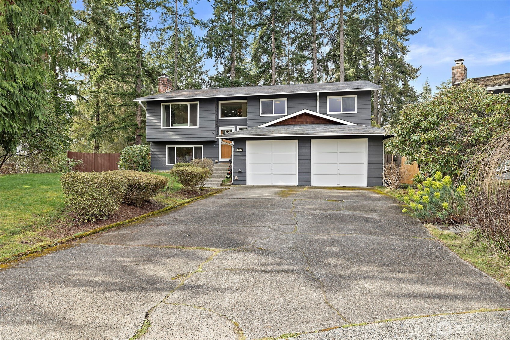 927 217th Street Southwest Bothell, WA 98021 - Photo 2 of 33 a front view of a house with a garden