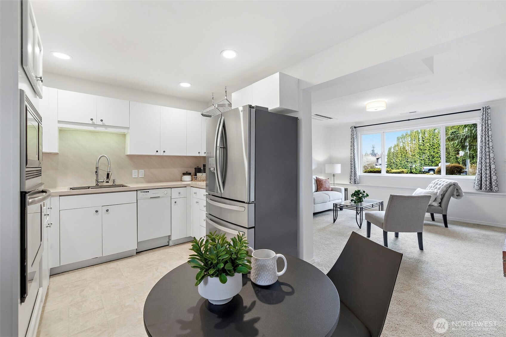 927 217th Street Southwest Bothell, WA 98021 - Photo 23 of 33 a kitchen with stainless steel appliances a dining table chairs and refrigerator