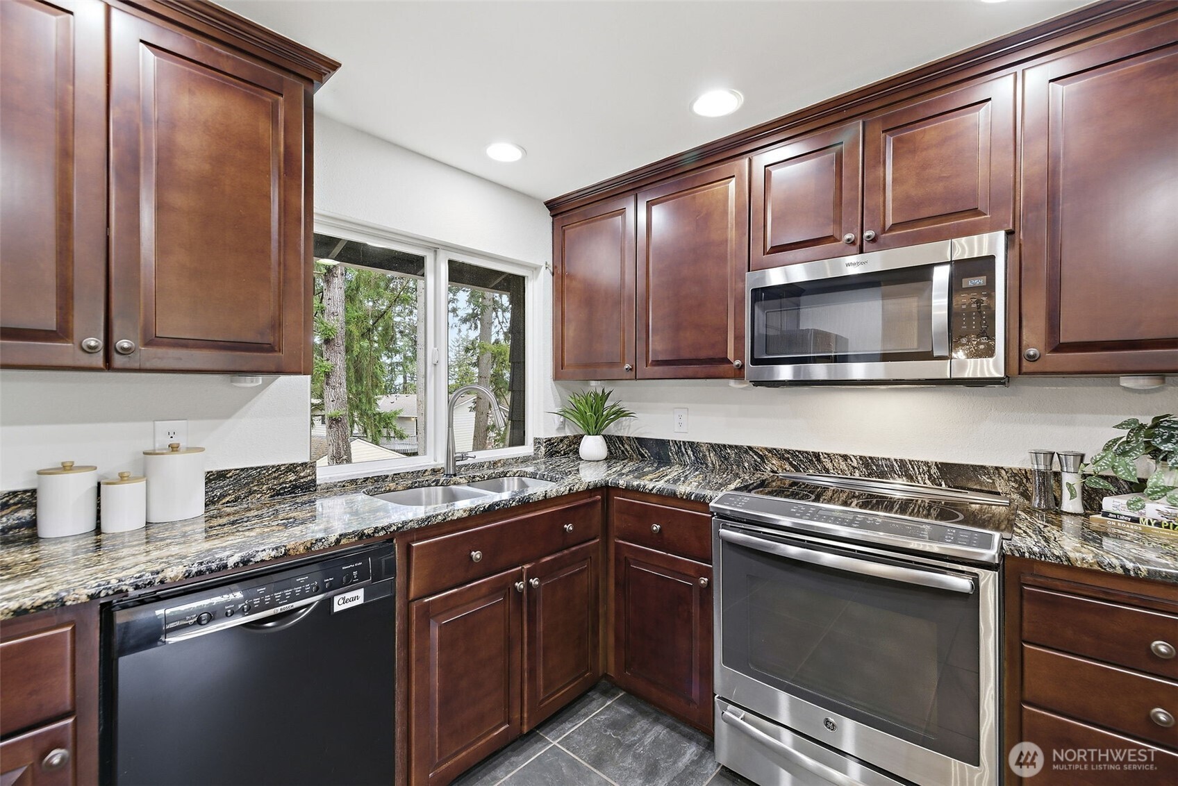 927 217th Street Southwest Bothell, WA 98021 - Photo 10 of 33 a kitchen with stainless steel appliances granite countertop wooden cabinets stove a sink and dishwasher