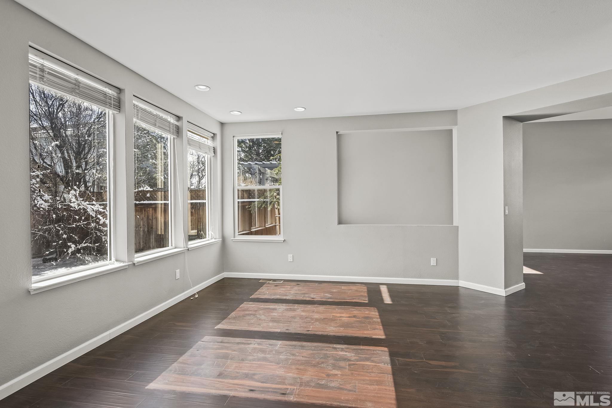 720 Caughlin Glen Reno, NV 89519 - Photo 11 of 24 a view of an empty room with wooden floor and a window