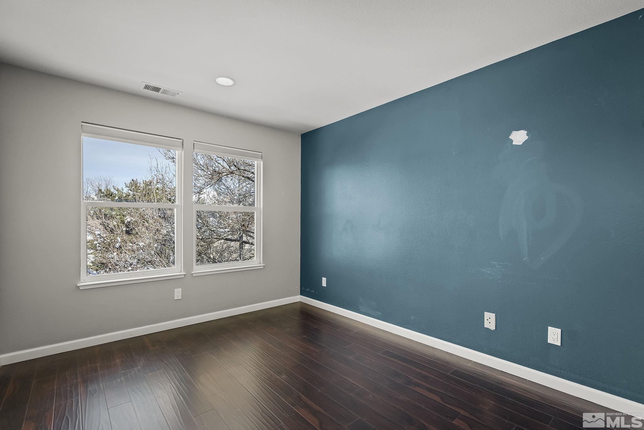 720 Caughlin Glen Reno, NV 89519 - Photo 18 of 24 a view of an empty room with wooden floor and a window