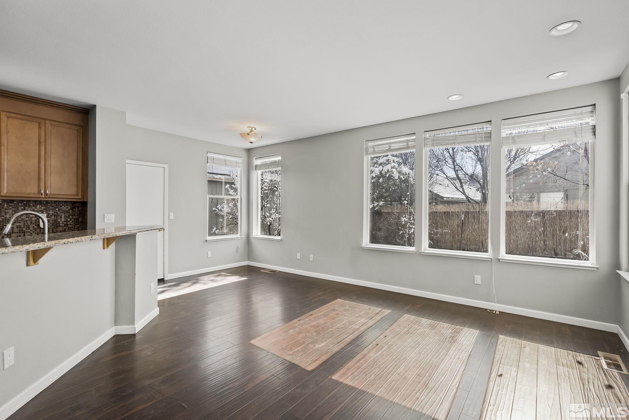 720 Caughlin Glen Reno, NV 89519 - Photo 8 of 24 an empty room with wooden floor and windows
