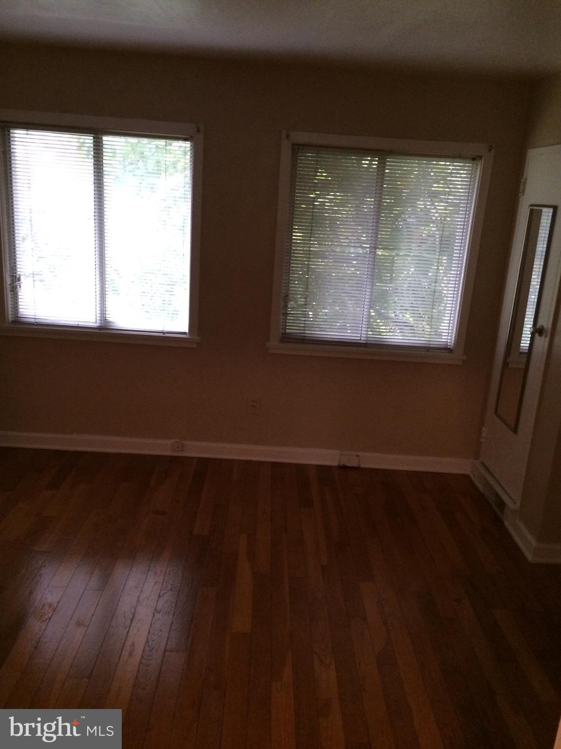 803 3rd Street Southwest, Unit 706 Washington, DC 20024 - Photo 8 of 18 a view of an empty room with wooden floor and a window